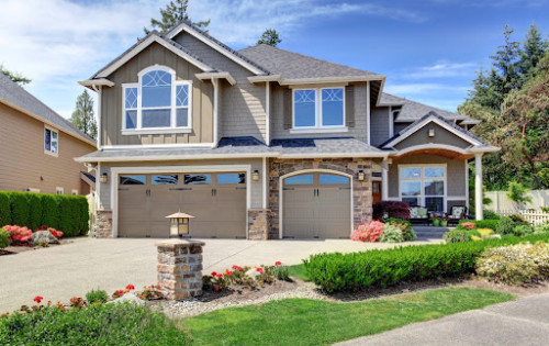 Beautiful home with two car garage during the daytime.